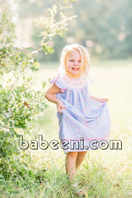 Lovely girl in geometric smocking dress