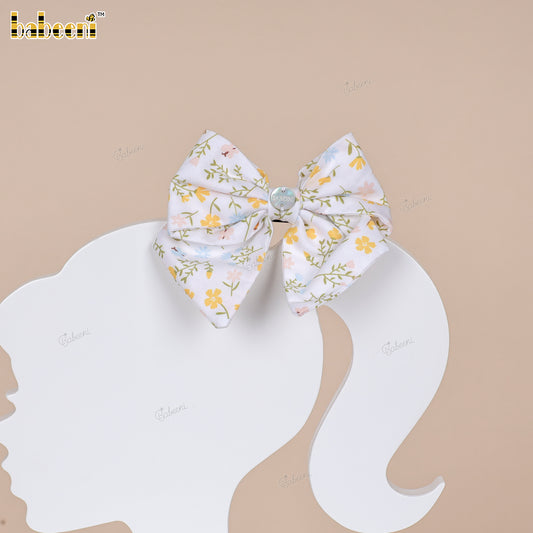 White floral fabric bow with glossy center accent - HB185