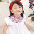 smocked-bishop-in-white-with-red-accent-around-neck-and-sleeve-for-girl